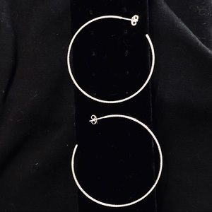 Large shimmery silver hoop earrings